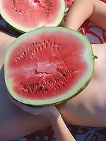 Adorable cutie enjoys her picnic with watermelon and shows off her perfect tits and pussy.
