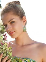 Yummy babe with beautiful wavy hair strips naked and shows off her natural unshaven pussy.