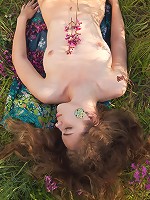 Yummy babe with beautiful wavy hair strips naked and shows off her natural unshaven pussy.