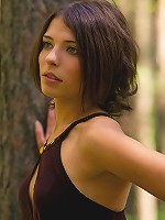 Appealing brunette strips her short dress in the woods to show off in all her nude glory.