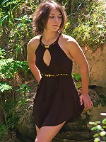 Appealing brunette strips her short dress in the woods to show off in all her nude glory.