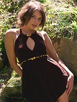 Appealing brunette strips her short dress in the woods to show off in all her nude glory.