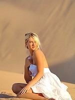 Alison Angel poses in her sexy white dress