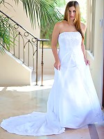 Danielle poses in a long white gown