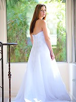 Danielle poses in a long white gown