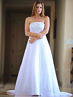 Danielle poses in a long white gown