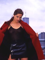 Gorgeous and sexy woman getting naked in front of a New York skyline.