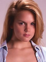 Fiery blonde slowly gets undressed in her apartment.