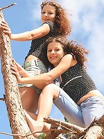 Two teens strip each other outdoors