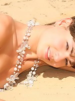 Cute brunette teen strips at the beach