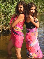 Two girls strip each other outdoors