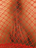 Teen wears see-thru red fishnet dress