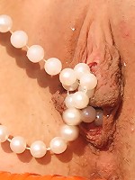 Horny teen puts pearls in her pussy