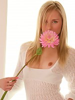 Kara pulls up her top and covers her pussy with a flower