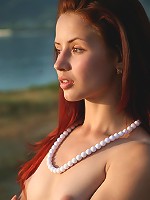 Redhead teen with small breasts posing nude in the old building