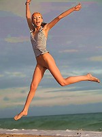 Very skinny and sporty teen jumping and flying naked on the beach