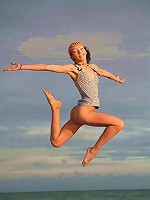 Very skinny and sporty teen jumping and flying naked on the beach