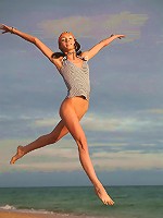 Very skinny and sporty teen jumping and flying naked on the beach