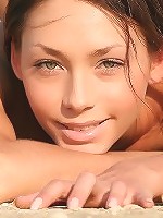 Tall skinny brunette taking off her transparent black dress on the beach