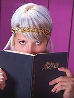 Brave goddess blonde is reading her favorite book on the chair indoors