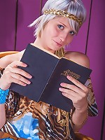 Brave goddess blonde is reading her favorite book on the chair indoors