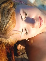 Redhead with small tits posing nude in the sunset