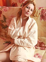 Sexy redhead with the big clit taking off her home gown and panties