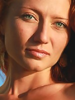 Petite young redhead girl getting nude on the beach