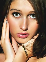 Green-eyed model with alluring face and puffy, round breasts.