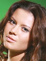 The vivid green background creates a refreshing ambiance for Emily's natural and confident beauty.