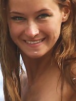 Fun and carefree, Masha frolics on beach, with sand and frothy water on her tight, untrimmed body.