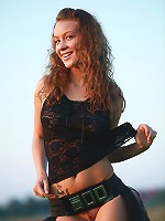 Beautiful Eva posing outdoors having just fancy belt on