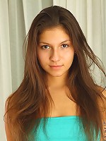 Nubiles.net Ania - College chick Ania spreads her legs wide open to show her pink pussy on the couch